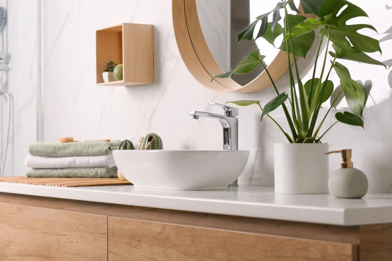 White bathroom vanity top with a vessel sink and wood cabinet